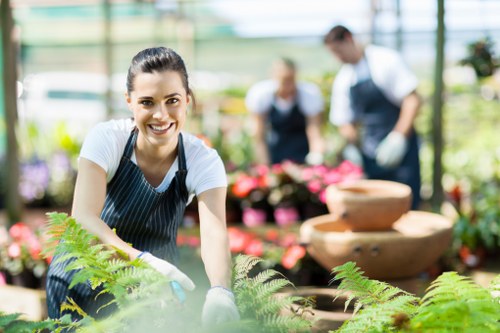 Volunteers sorting garden waste into labelled containers
